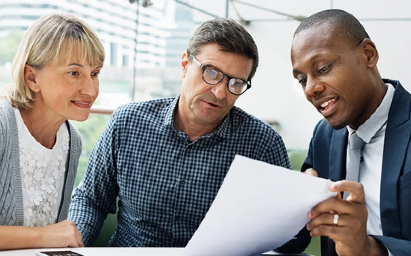 Professional couple meeting with a financial advisor to discuss retirement planning and retirement income strategies.
