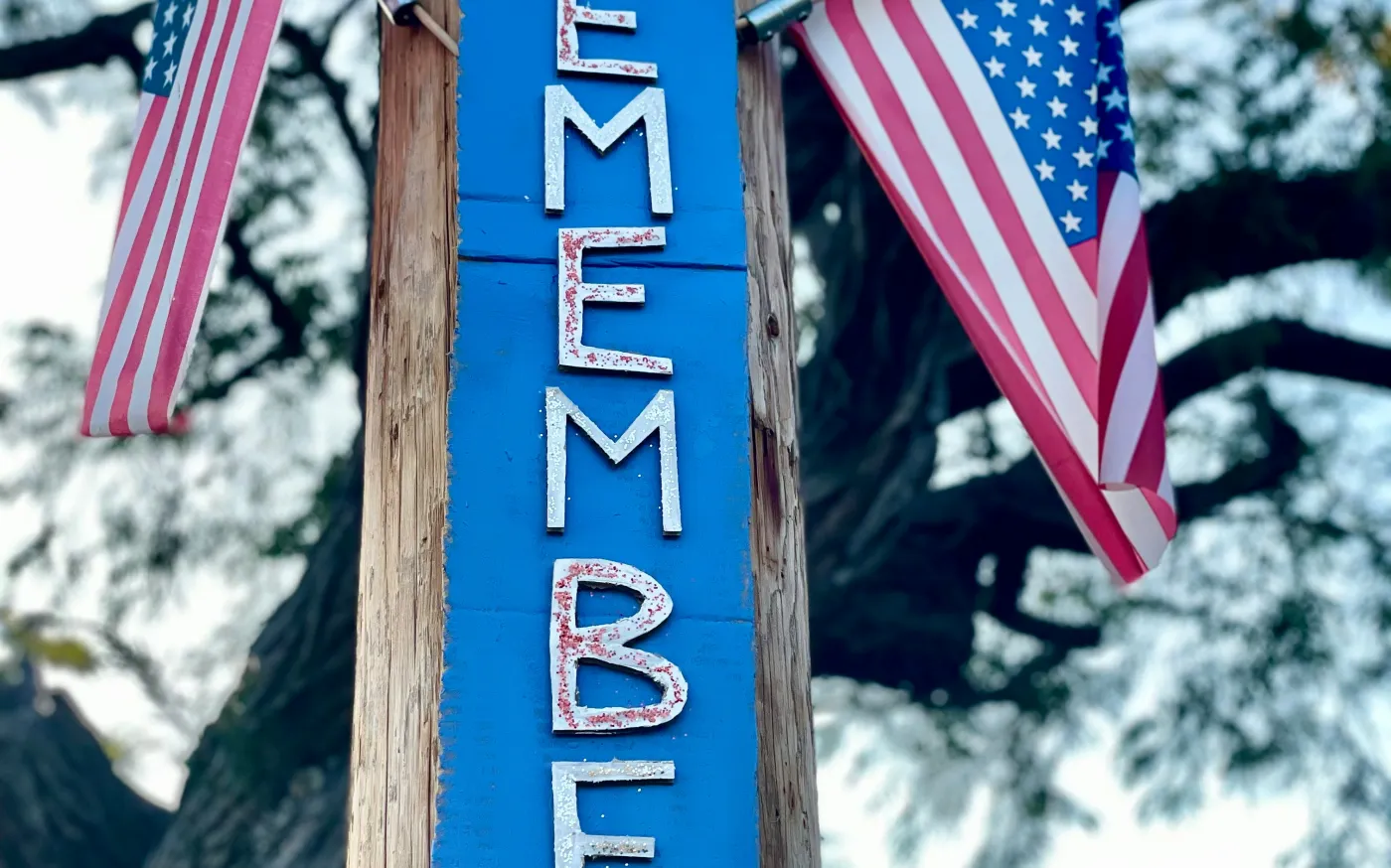 “Remember” sign surrounded by American flags symbolizing Memorial Day reflection and remembrance  Option 3