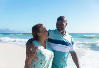 Retired couple walking on the beach
