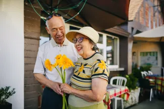 Retired couple walking hand in hand outdoors, representing retirement planning for couples.