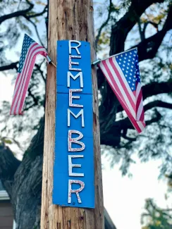 “Remember” sign surrounded by American flags symbolizing Memorial Day reflection and remembrance  Option 3