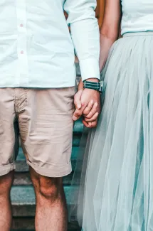 Married couple holding hands, representing retirement planning and having a power of attorney in place for Greensboro, NC couples working with a financial advisor.