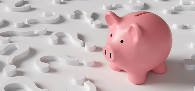 Piggy bank surrounded by question marks representing families trying to understand the new Trump Accounts savings program for children.