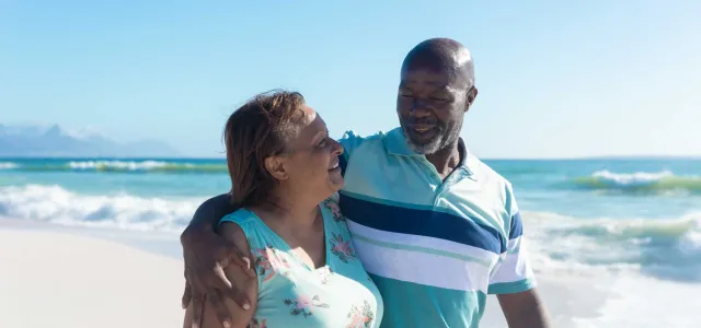 Retired couple walking on the beach