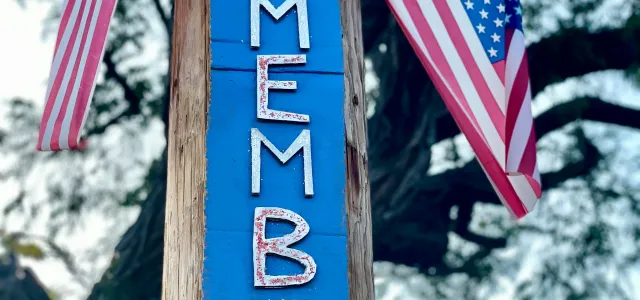 “Remember” sign surrounded by American flags symbolizing Memorial Day reflection and remembrance  Option 3