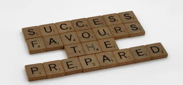 Scrabble tiles spelling ‘success favors the prepared’ representing retirement planning for individuals 50 and over in Greensboro, NC