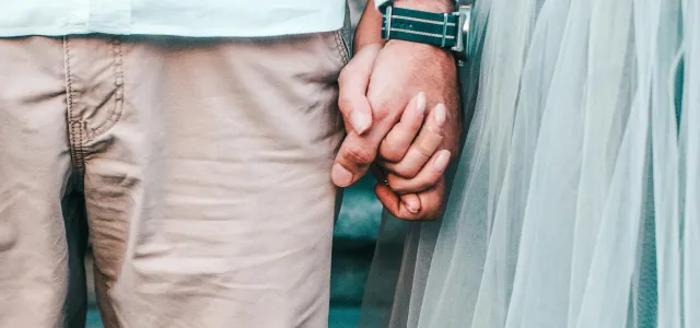 Married couple holding hands, representing retirement planning and having a power of attorney in place for Greensboro, NC couples working with a financial advisor.